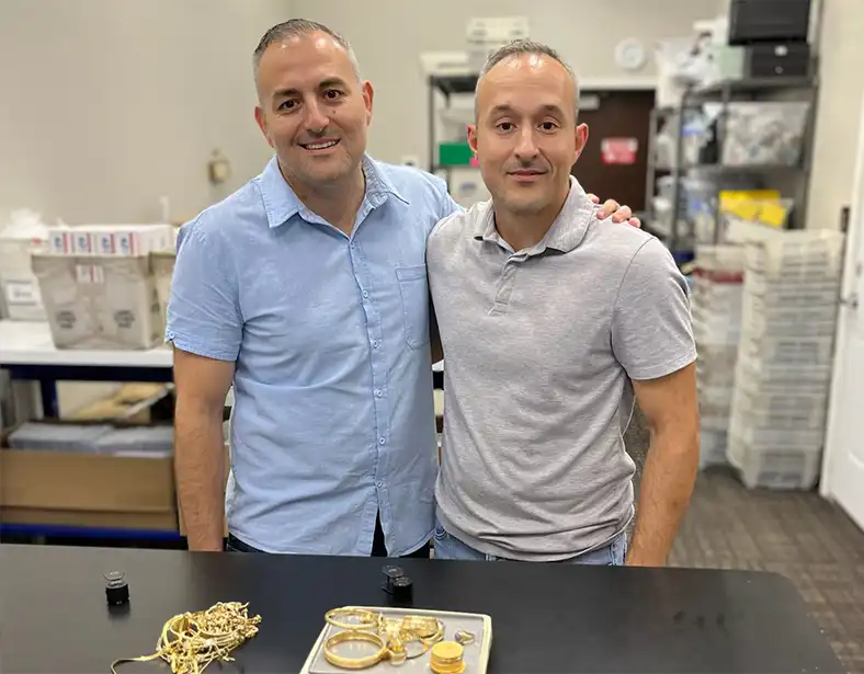 Photo of business owners standing in front of gold